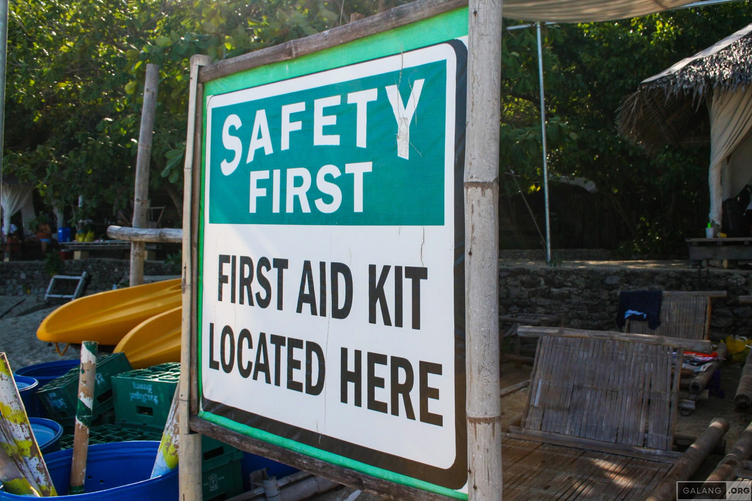 “Safety First. First Aid Kit Located Here” (Where?)